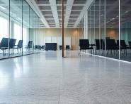 flooring quality inspection, carefully evaluating surface evenness, diligently checking for imperfections, photorealistic, sleek modern office space with glass partitions, highly detailed, subtle texture on concrete tiles, 50mm lens, neutral greys and sharp blacks, bright LED lighting, shot with an industrial-grade camera